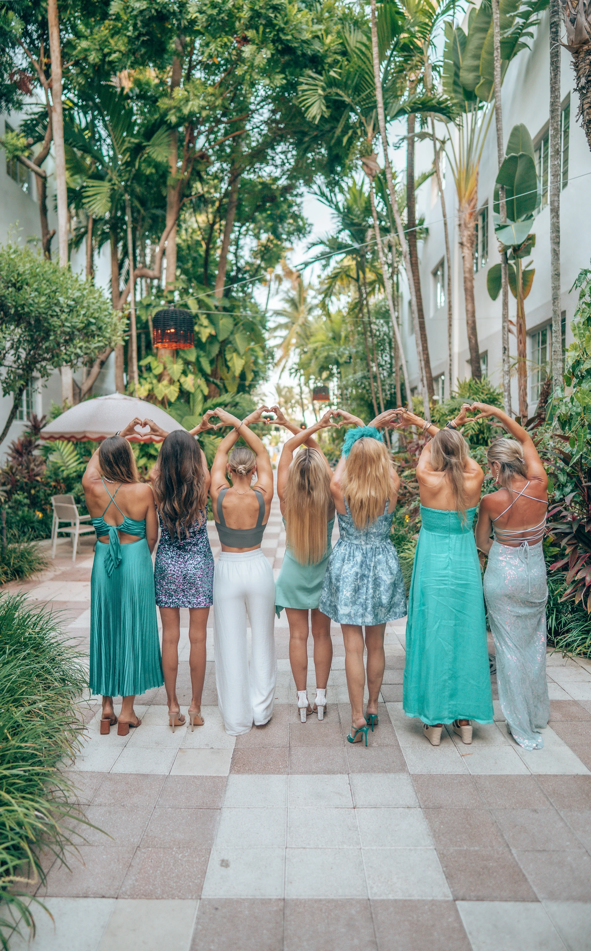 Women making heart shapes with their hands - sisterhood at Starseed Summit