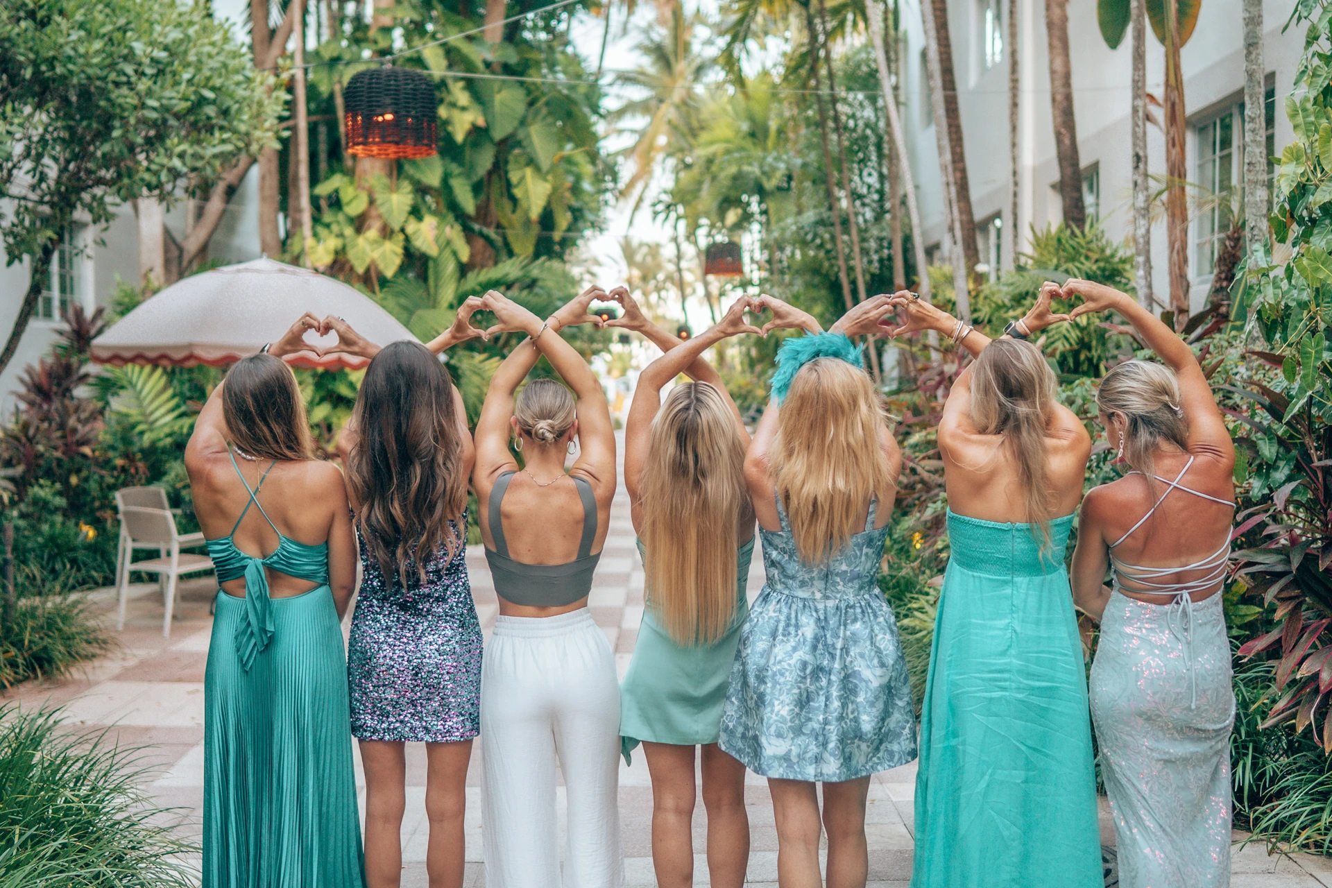 Women making heart shapes with their hands - sisterhood at Starseed Summit