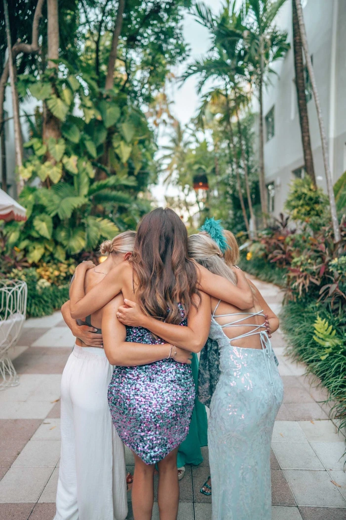 Women huddling together sharing secrets about the upcoming speaker lineup