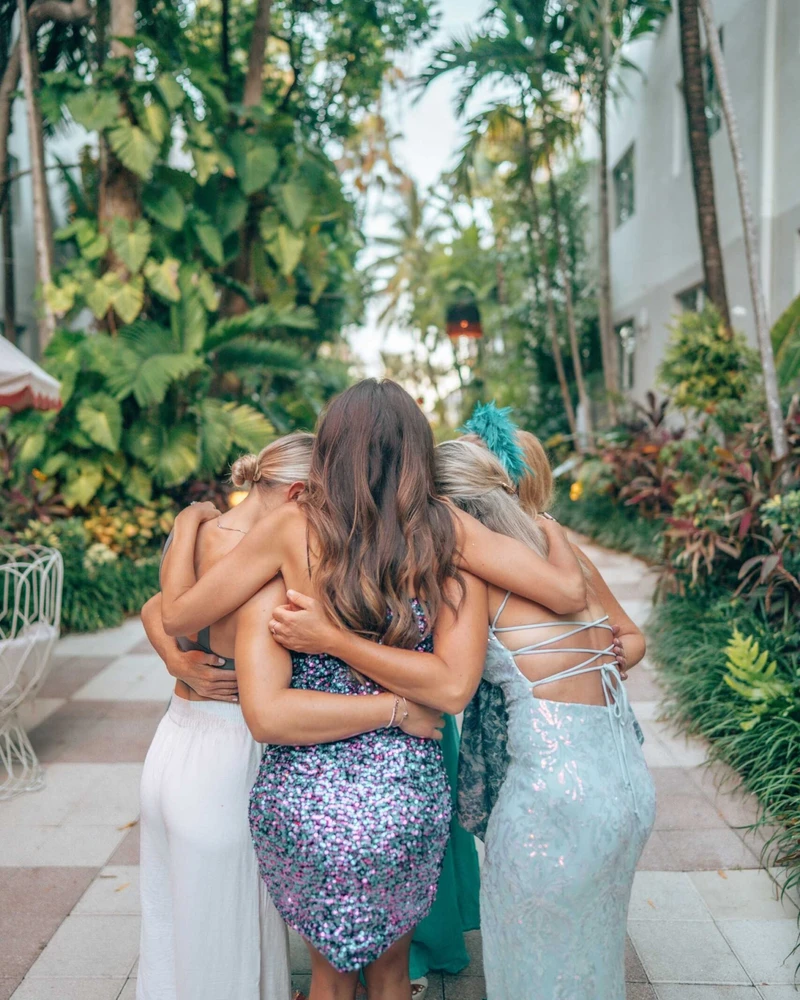 VIP supper club - women in glamorous dresses embracing